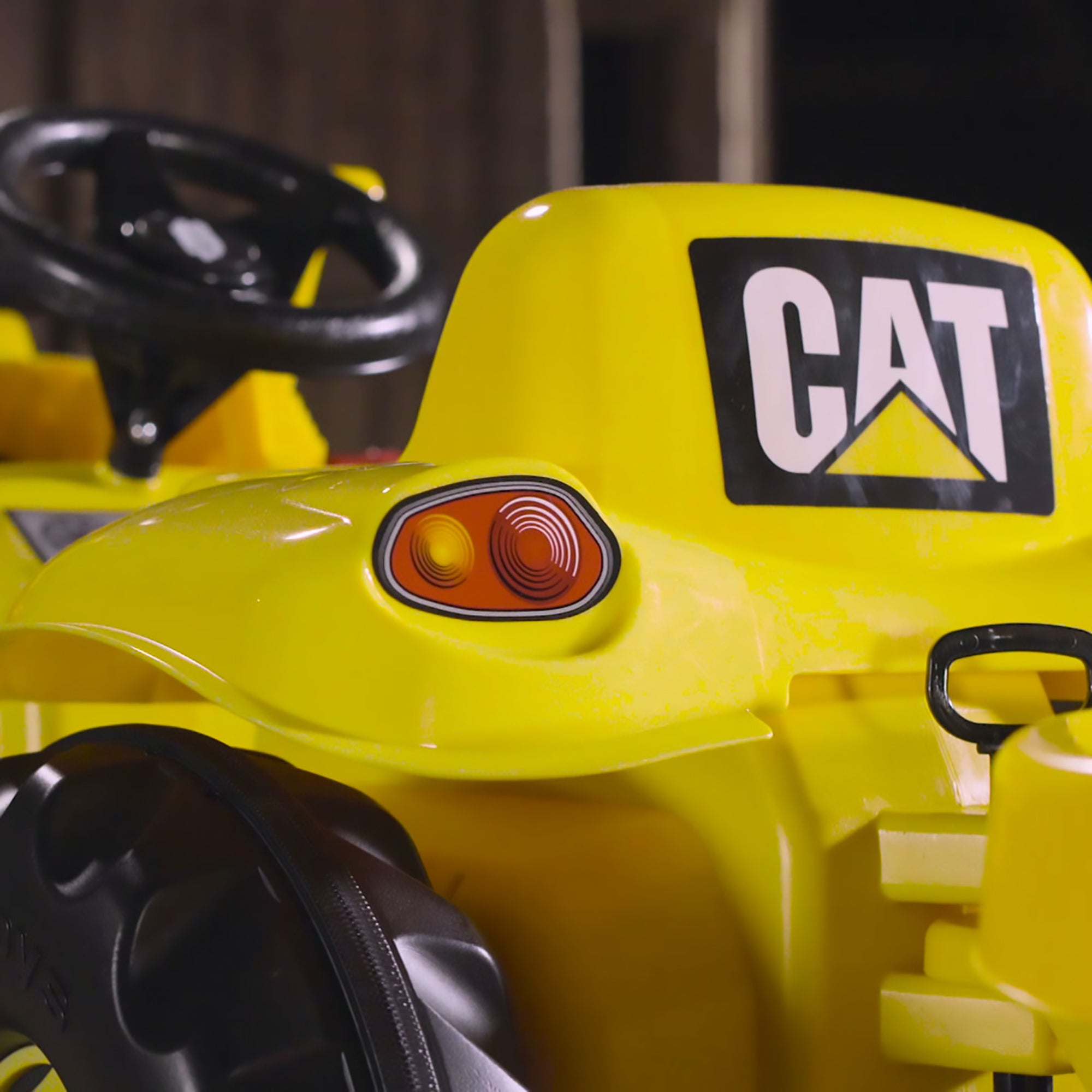 Closeup image of the back of the seat on a CAT Kid Tractor