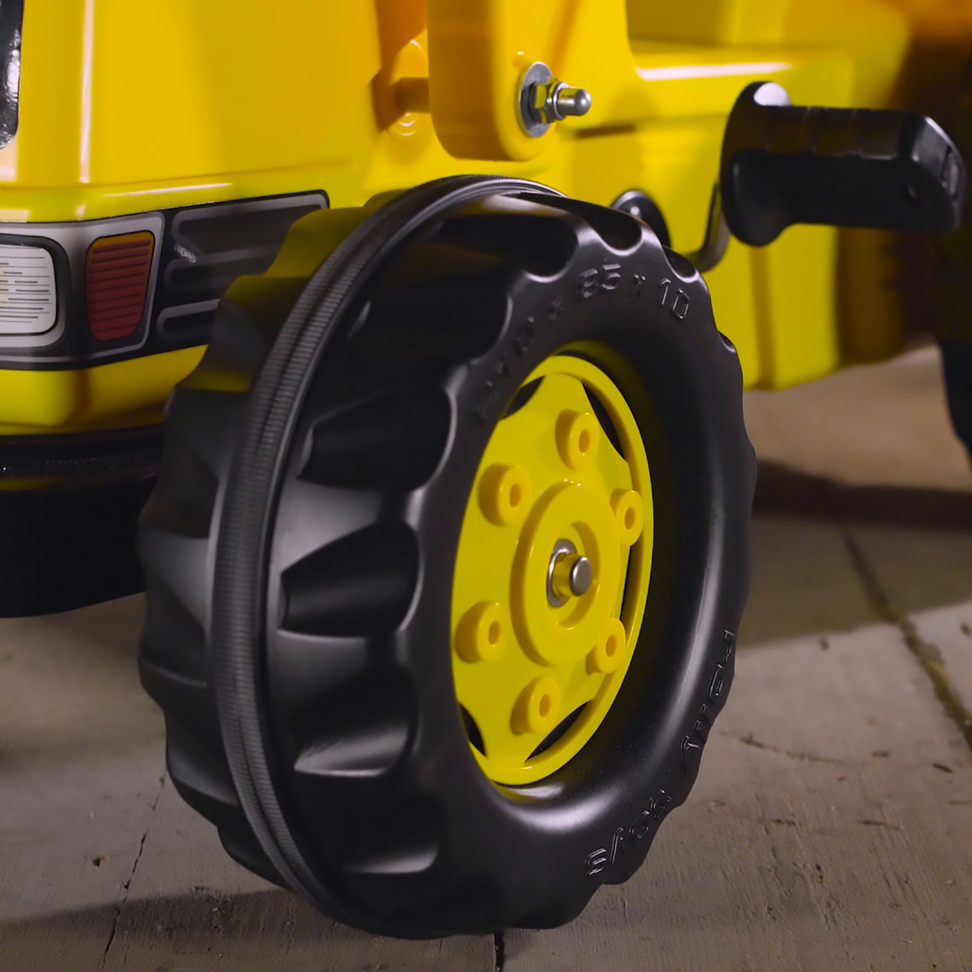 Closeup image of the wheel on the CAT Kid Tractor.