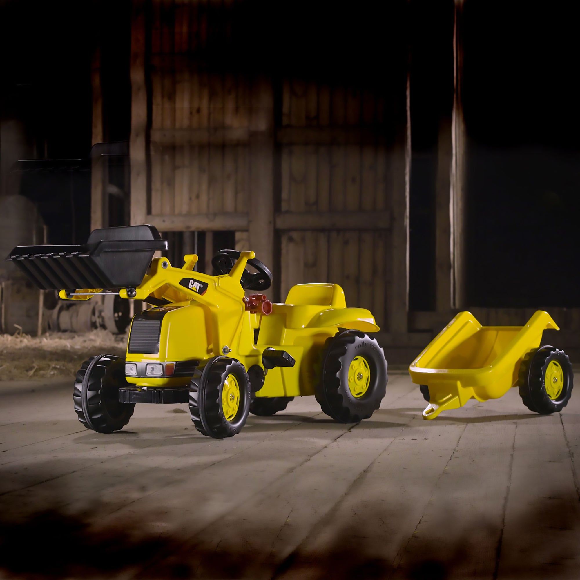Image of the CAT kid tractor in a barn.