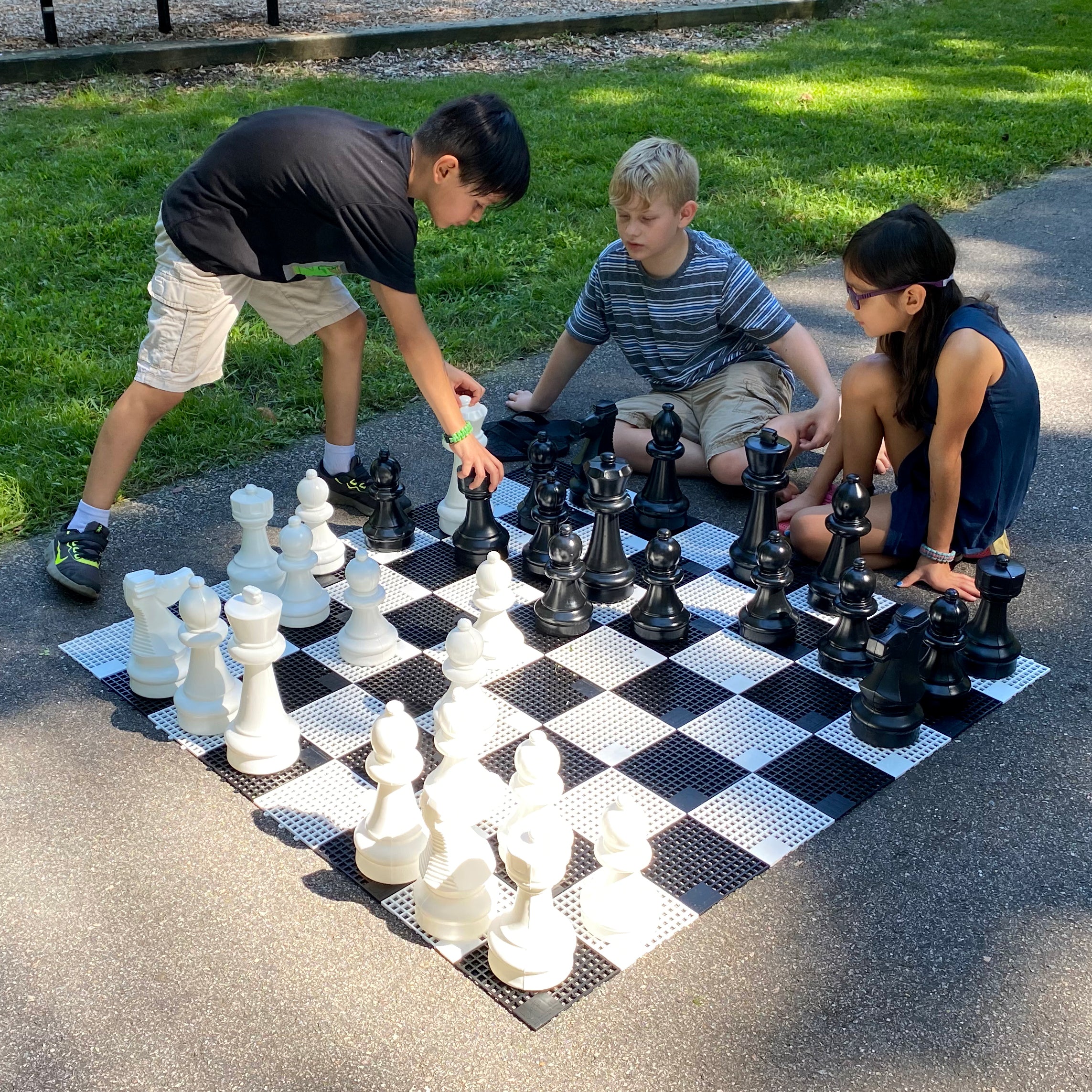 Kids playing outside on the Mini-Giant Chess Set