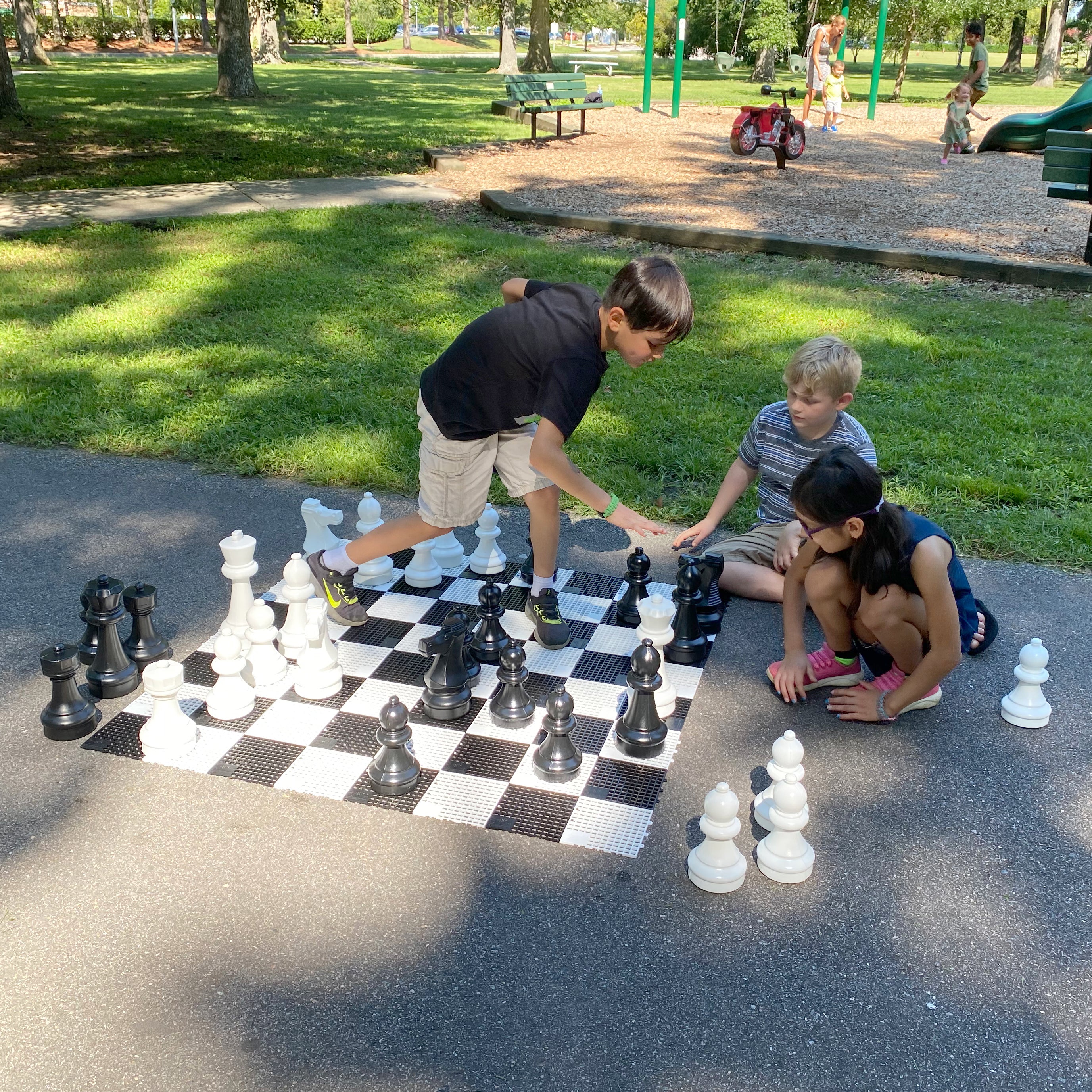 Kids playing outside on the Mini-Giant Chess Set