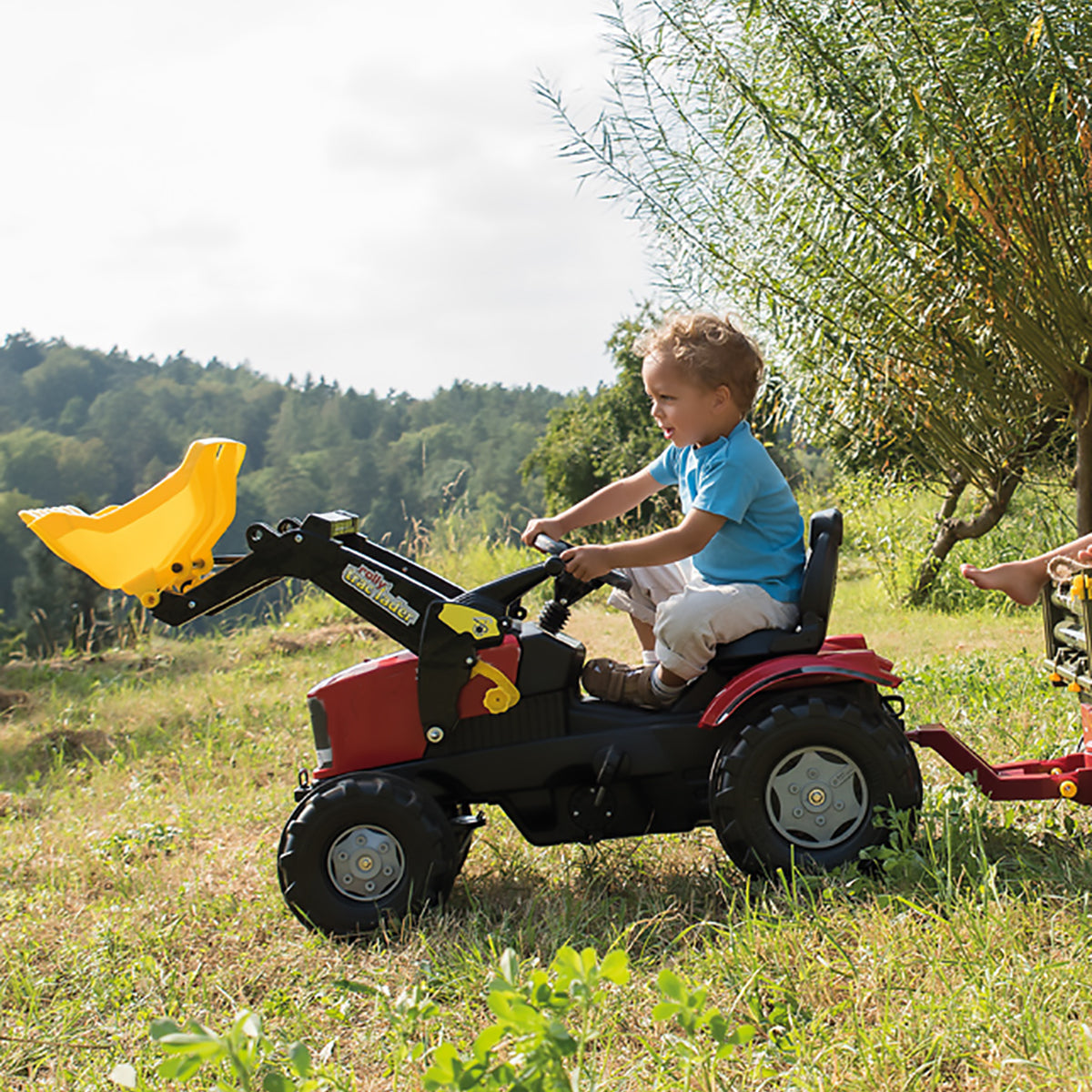 Image of a young boy playing on a CASE Farmtrac Front Loader