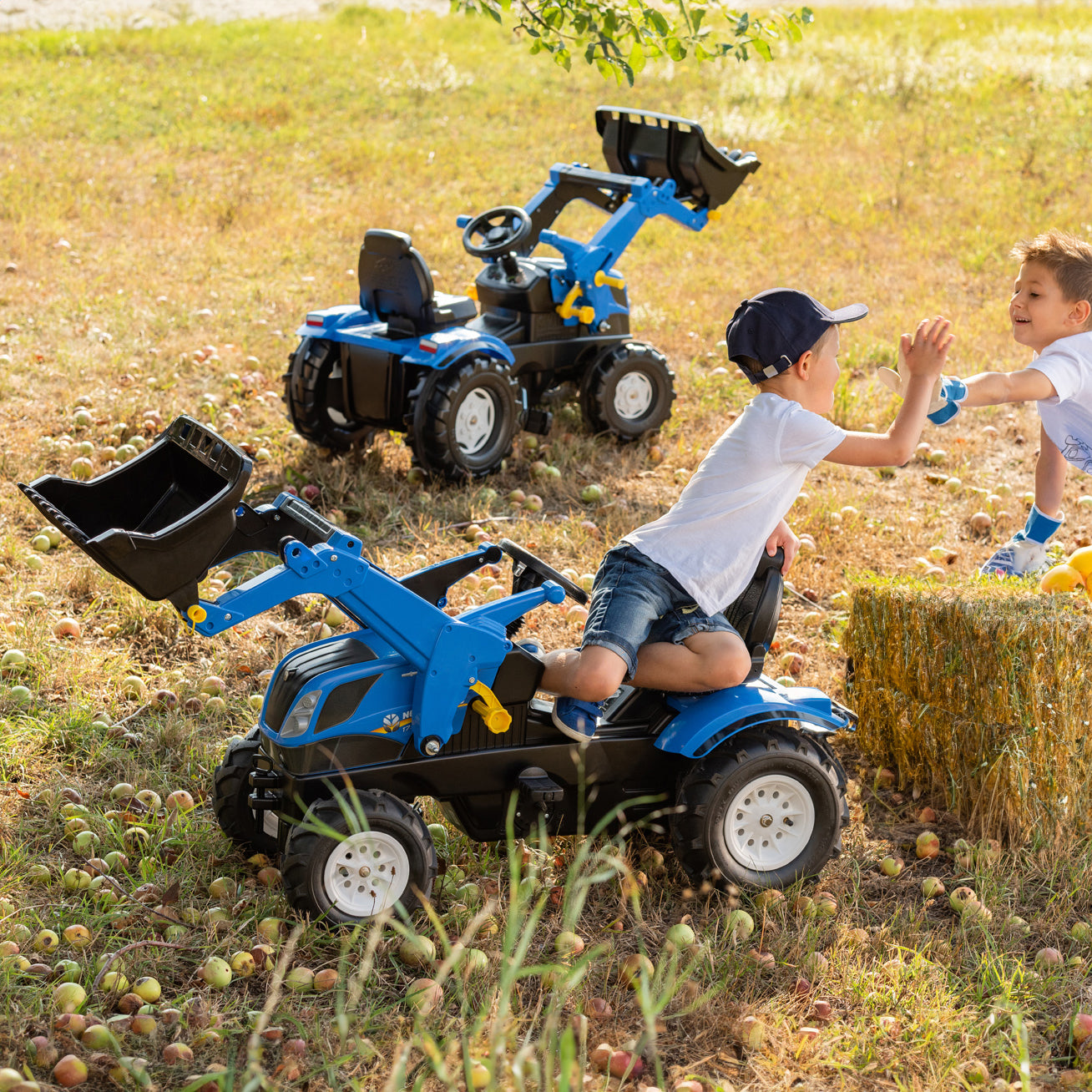 Kids playing on the New Holland Front Loader with Air Tires