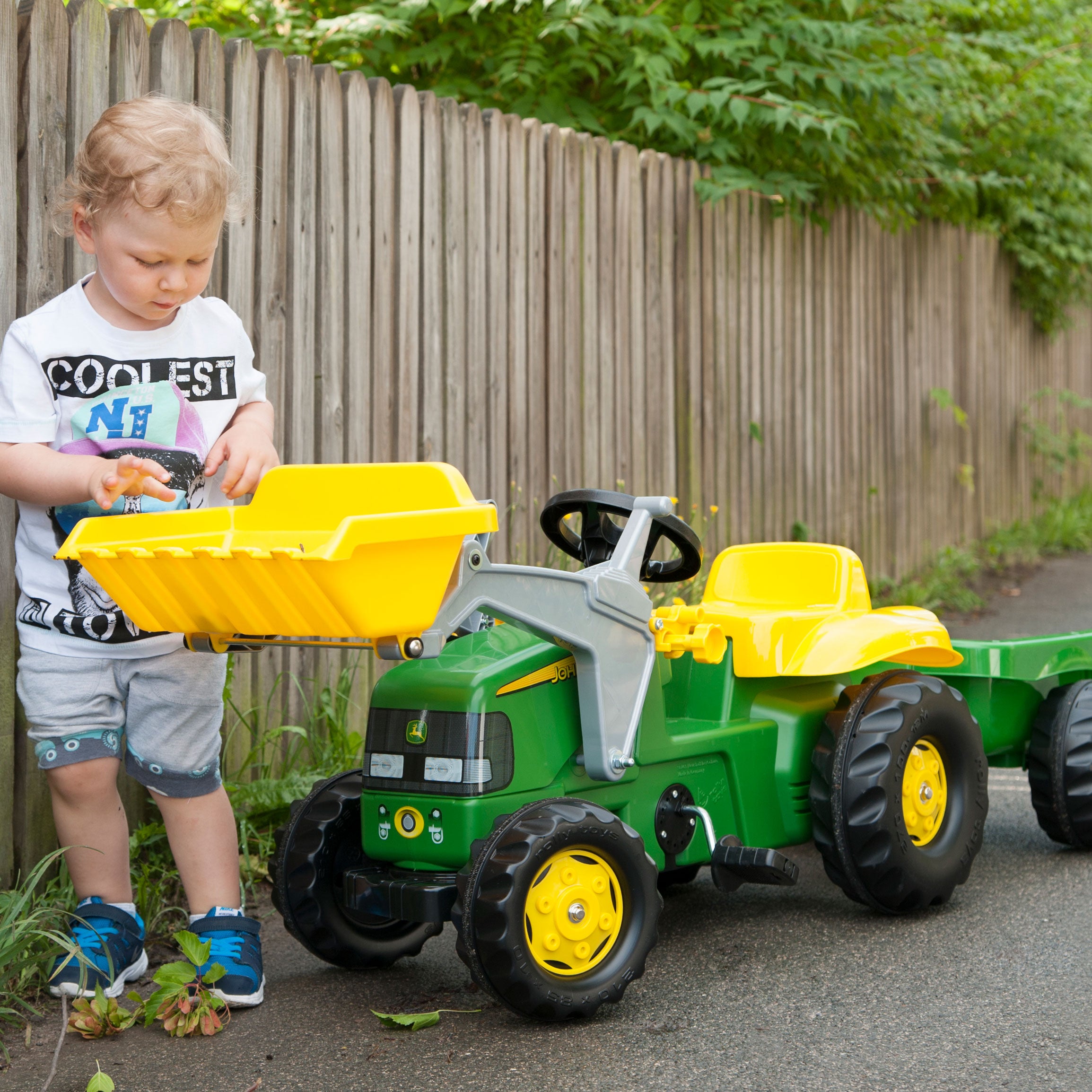 Lifestyle of boy playing with the John Deere Pedal Tractor with Loader