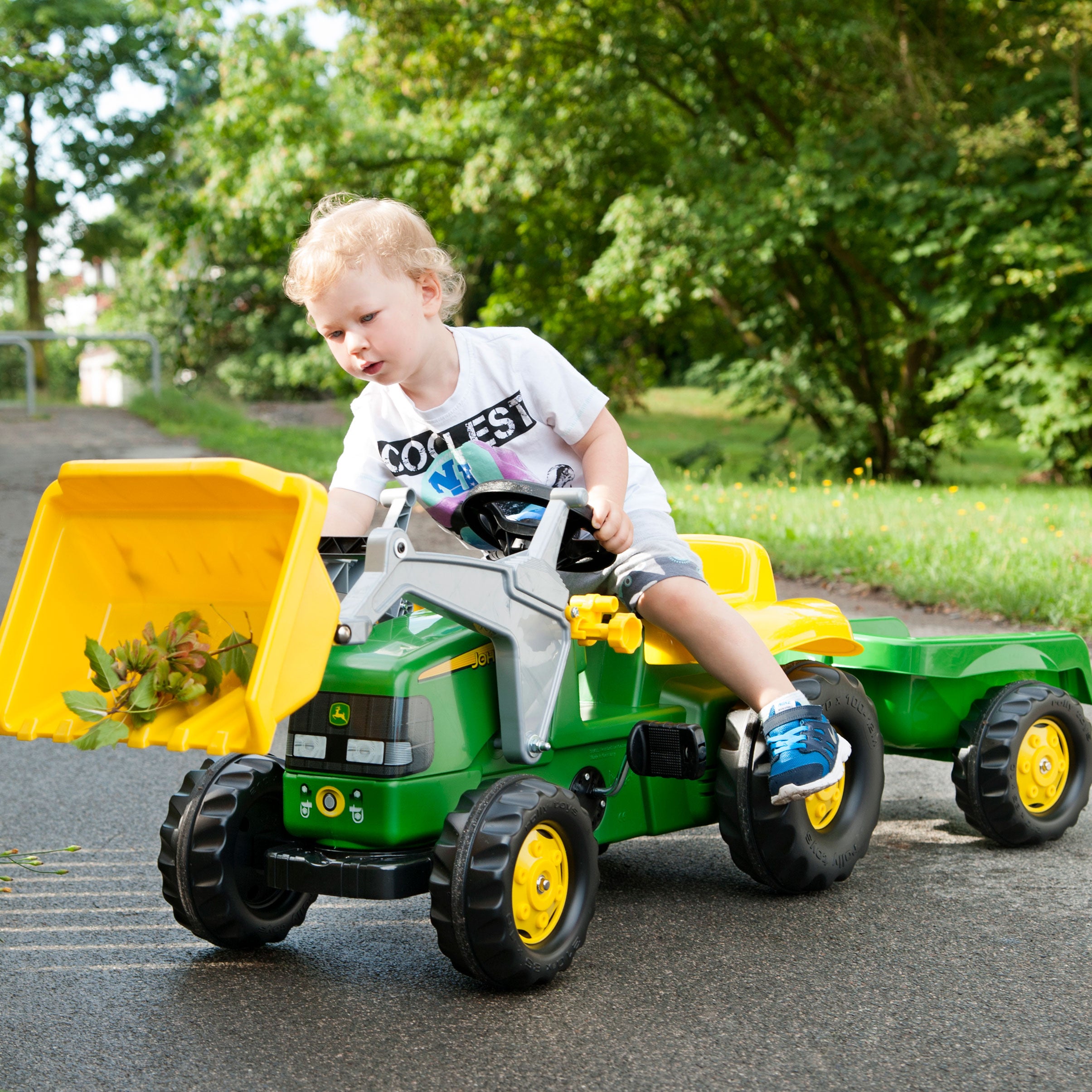 Lifestyle of boy playing with the John Deere Pedal Tractor with Loader