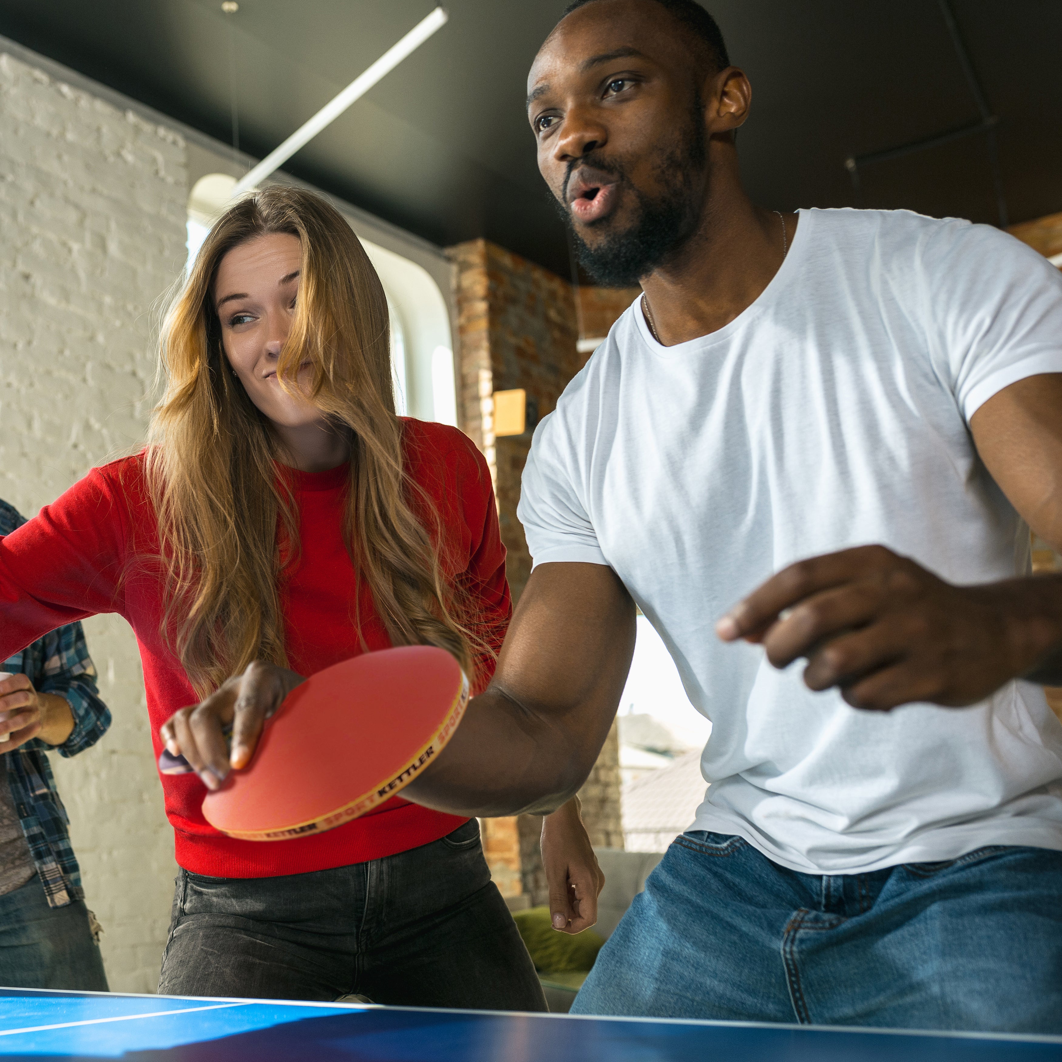 Friends playing table tennis with the GTX-85 4-Player Set