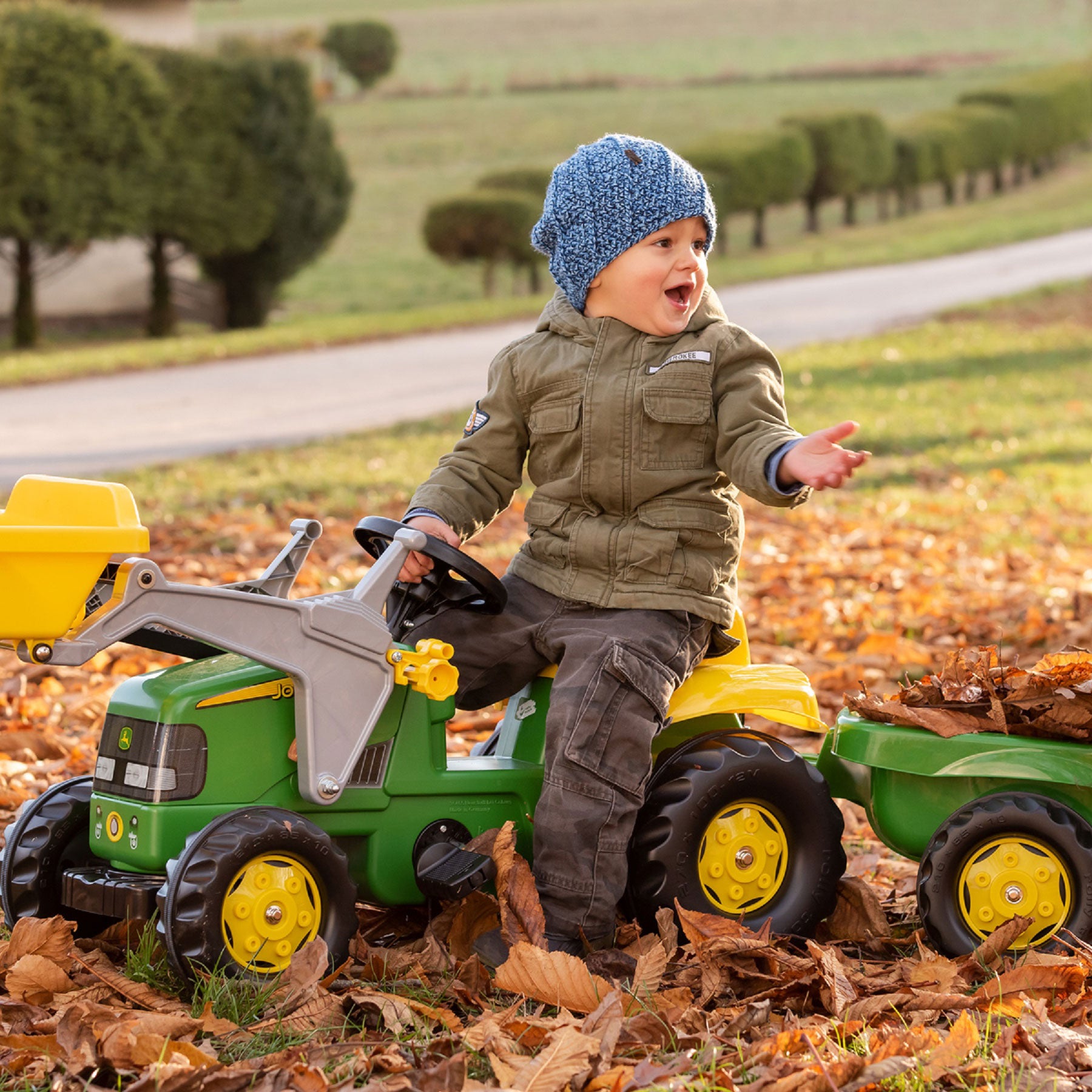 Lifestyle of boy playing with the John Deere Pedal Tractor with Loader