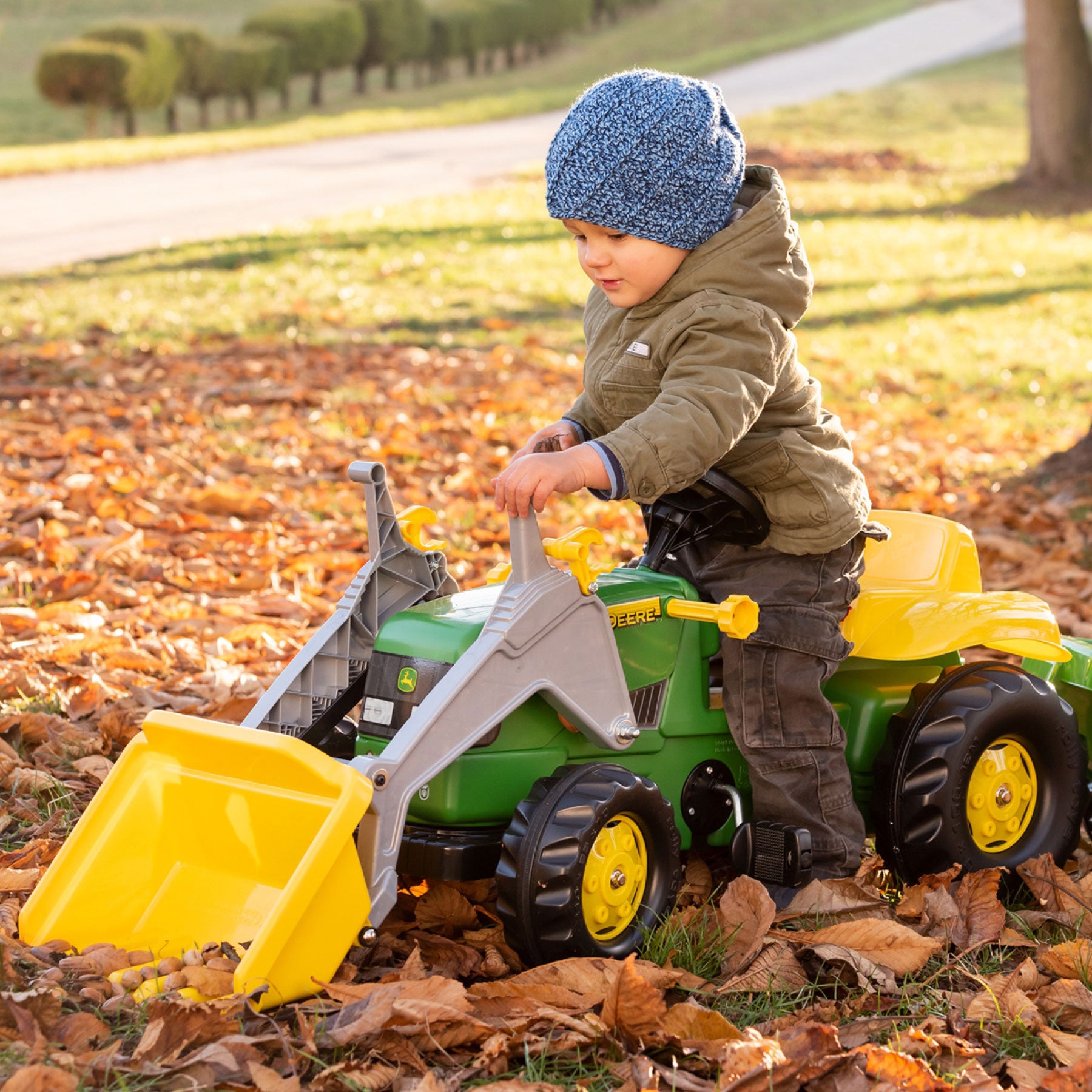 Lifestyle of boy playing with the John Deere Pedal Tractor with Loader